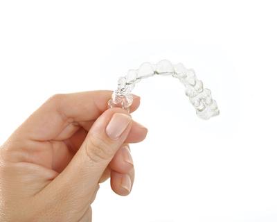 clear aligners whitsundays | person holding clear aligners